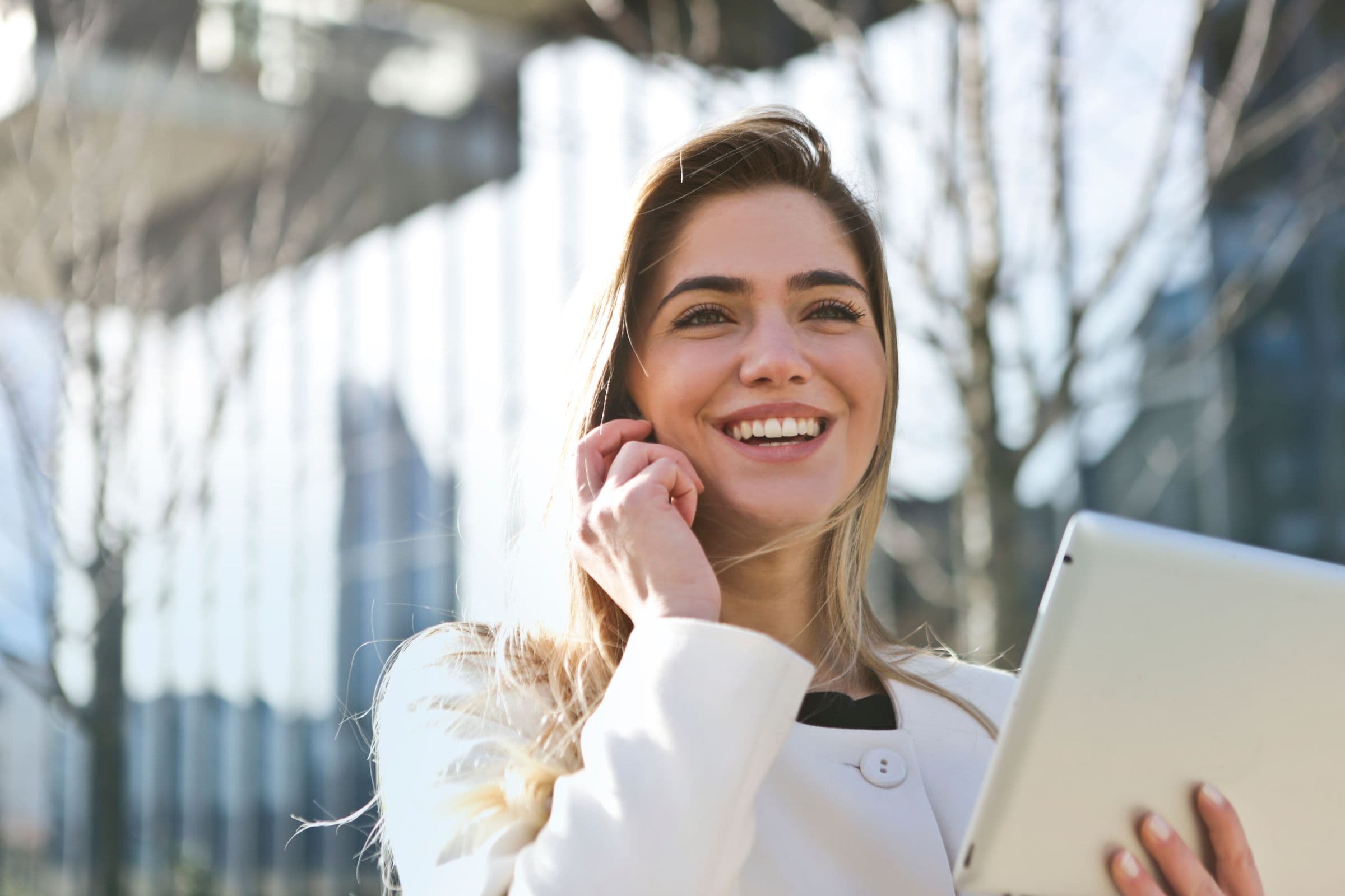 Smiling professional on a phone call outdoors, ready for live interpreting